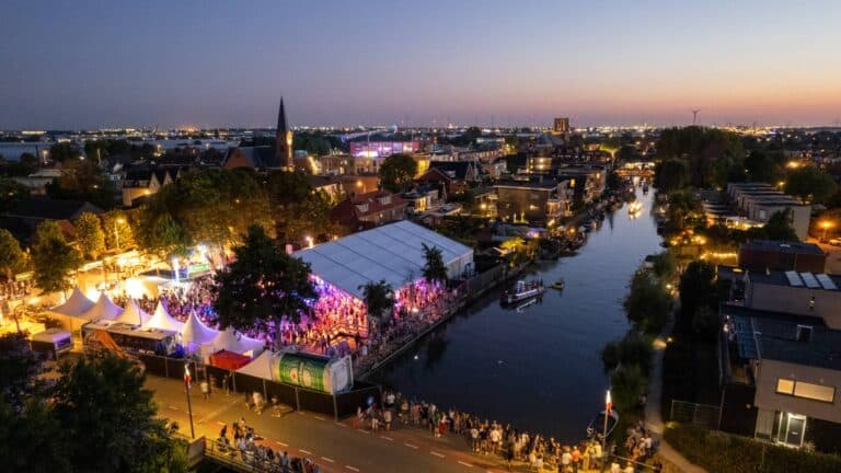 luchtfoto van de Bradelier de jaarlijkse feestweek in De Lier met de rivier de Lee en een grote feesttent in beeld